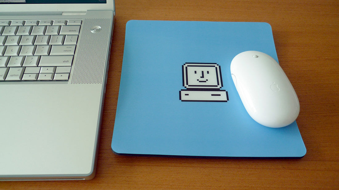 A blue mousepad showing the apple startup icon